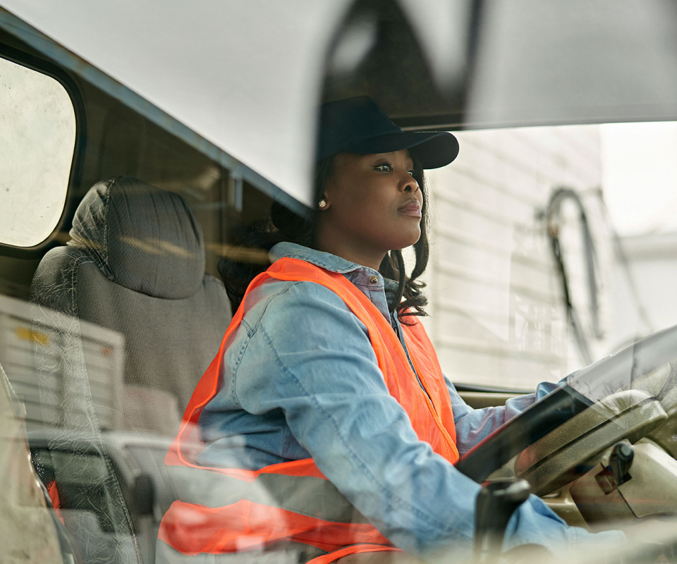 Woman truck driver in cab