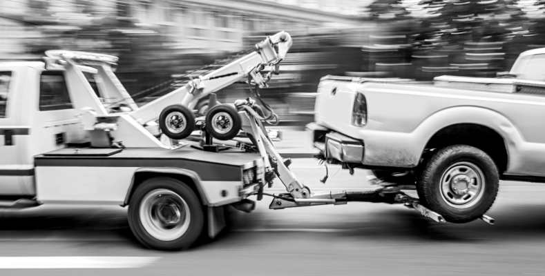 police department tow truck delivers the damaged vehicle in monochrome blue tonality